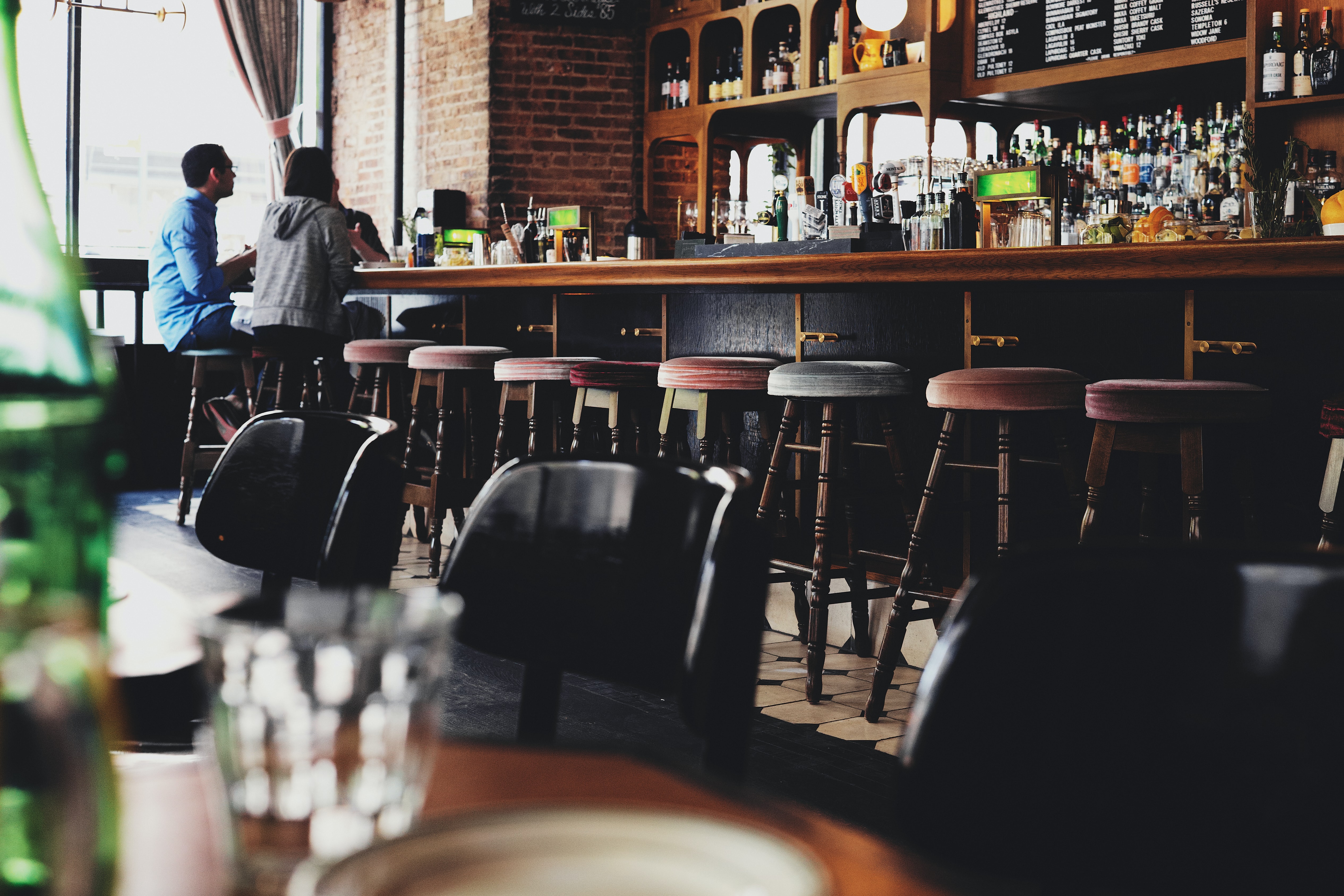 Three people sitting at a bar